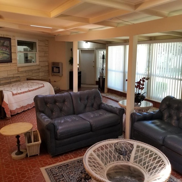 living room featuring beam ceiling, heating unit, and coffered ceiling