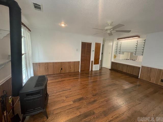 interior space with a textured ceiling, plenty of natural light, dark hardwood / wood-style floors, and ceiling fan