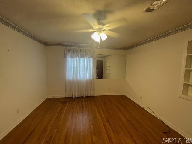 spare room featuring ceiling fan and dark hardwood / wood-style flooring