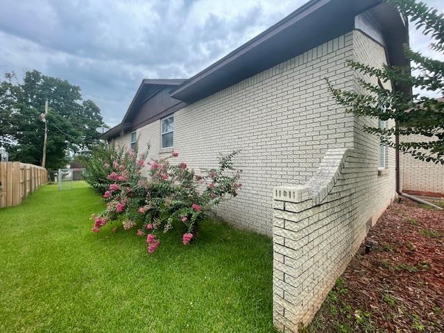 view of side of property featuring a yard