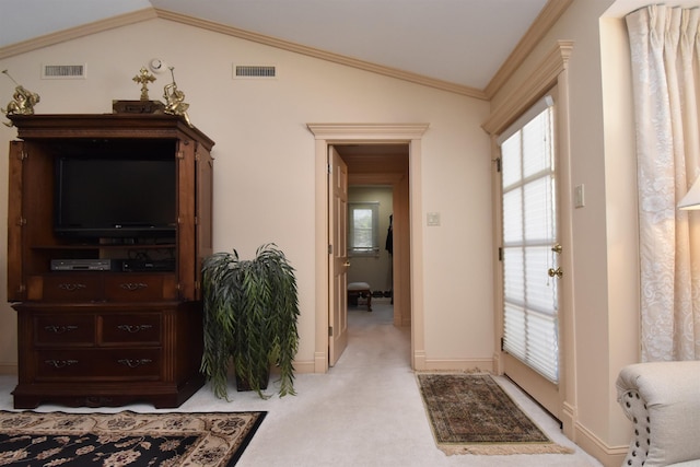 interior space with light carpet, vaulted ceiling, and ornamental molding