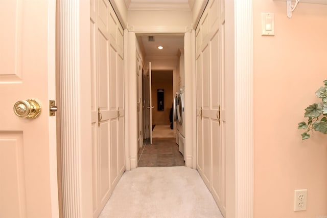 hallway featuring light colored carpet and ornamental molding