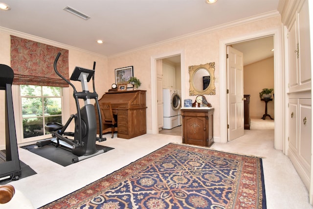 exercise area featuring light carpet, washer / dryer, and crown molding