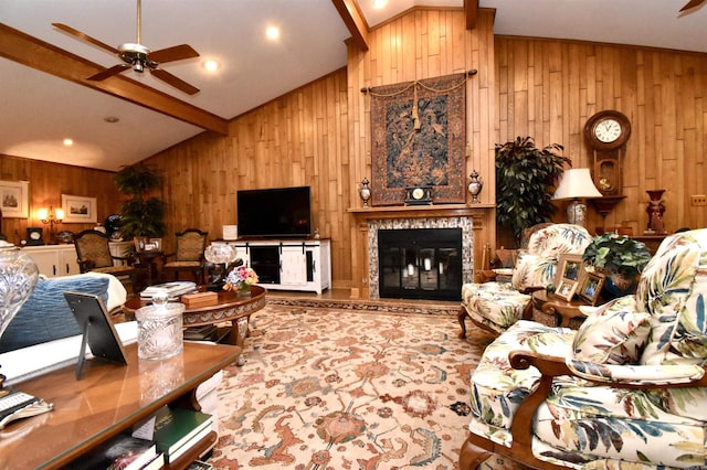 living room with ceiling fan, high vaulted ceiling, beam ceiling, and wood walls