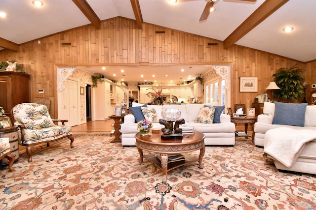 living room with lofted ceiling with beams, ceiling fan, and wood walls