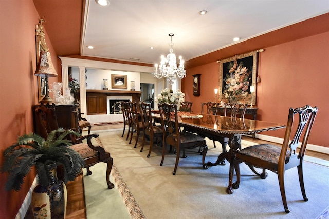 dining area featuring light colored carpet and a chandelier