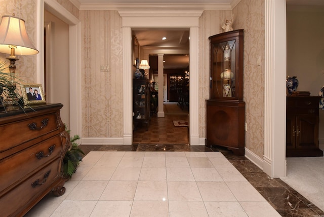 hallway featuring ornamental molding and ornate columns