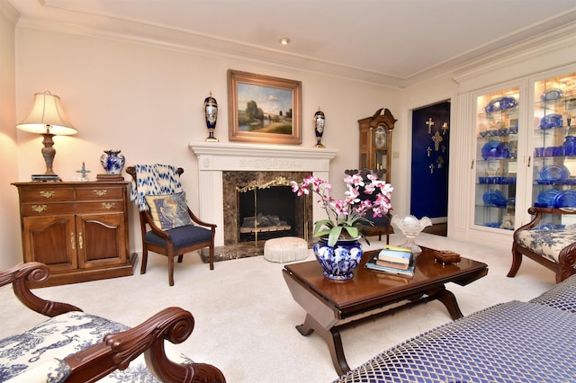 carpeted living room featuring crown molding and a high end fireplace