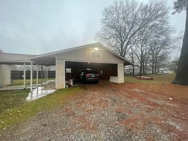 exterior space with a carport and a yard