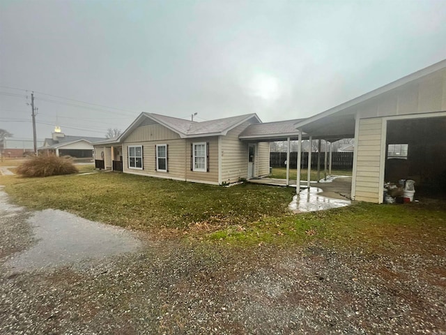 view of property exterior featuring a carport and a lawn