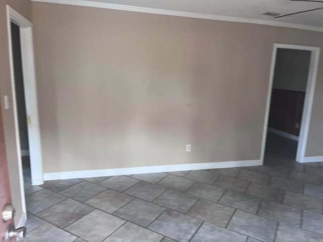 tiled empty room featuring crown molding and ceiling fan