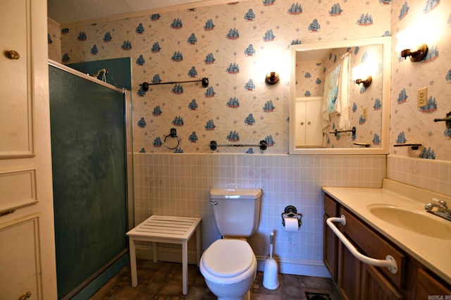 bathroom with vanity, tile walls, toilet, a textured ceiling, and tile patterned flooring