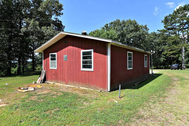 view of outbuilding featuring a yard