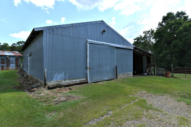 view of outbuilding with a yard