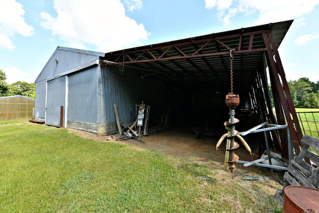 view of outbuilding with a yard