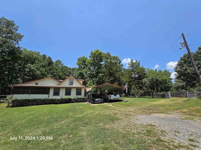 view of front of home with a carport and a front yard