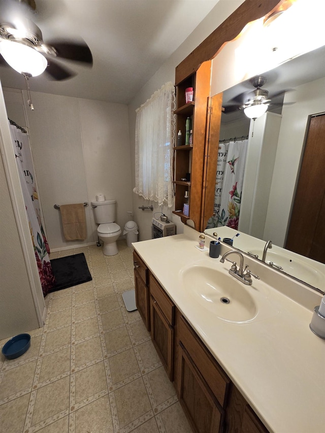 bathroom featuring vanity, toilet, and ceiling fan