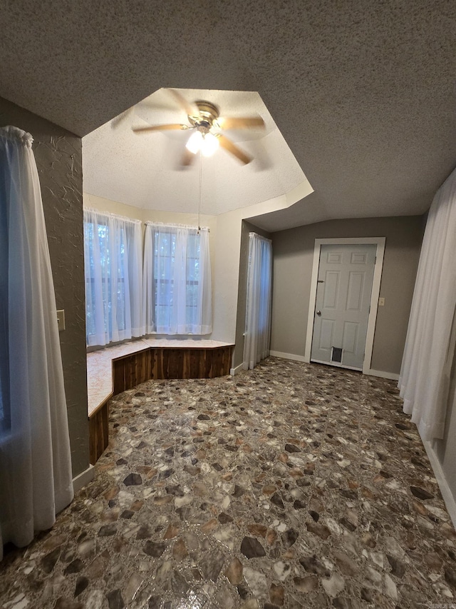 interior space featuring ceiling fan and a textured ceiling