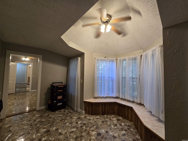 interior space with ceiling fan and a textured ceiling