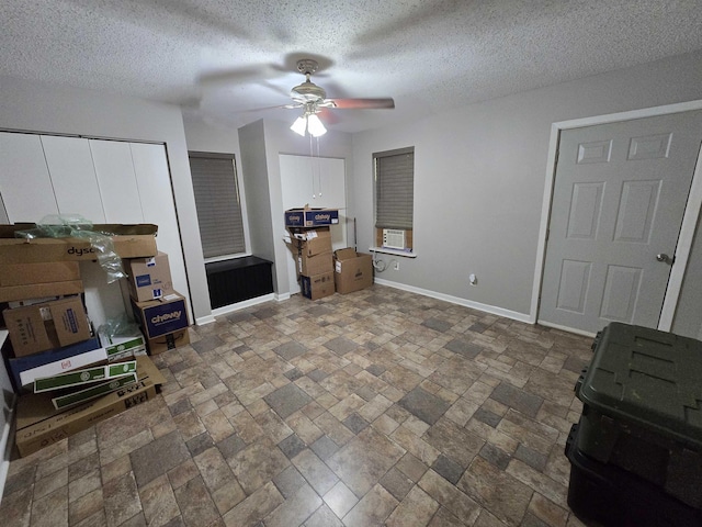 living room with ceiling fan and a textured ceiling