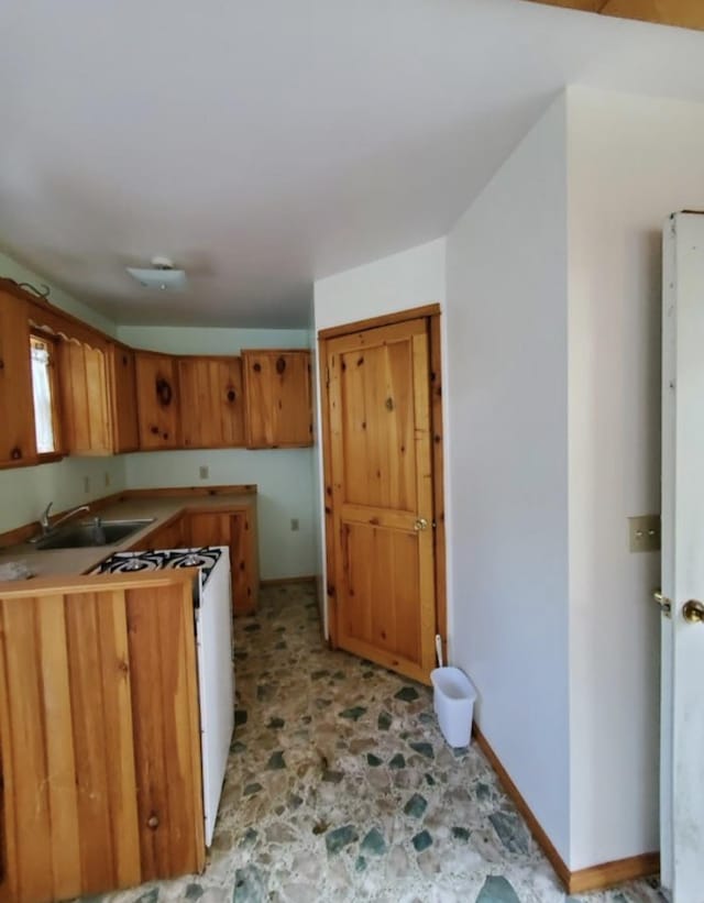 kitchen with sink and white range with gas stovetop