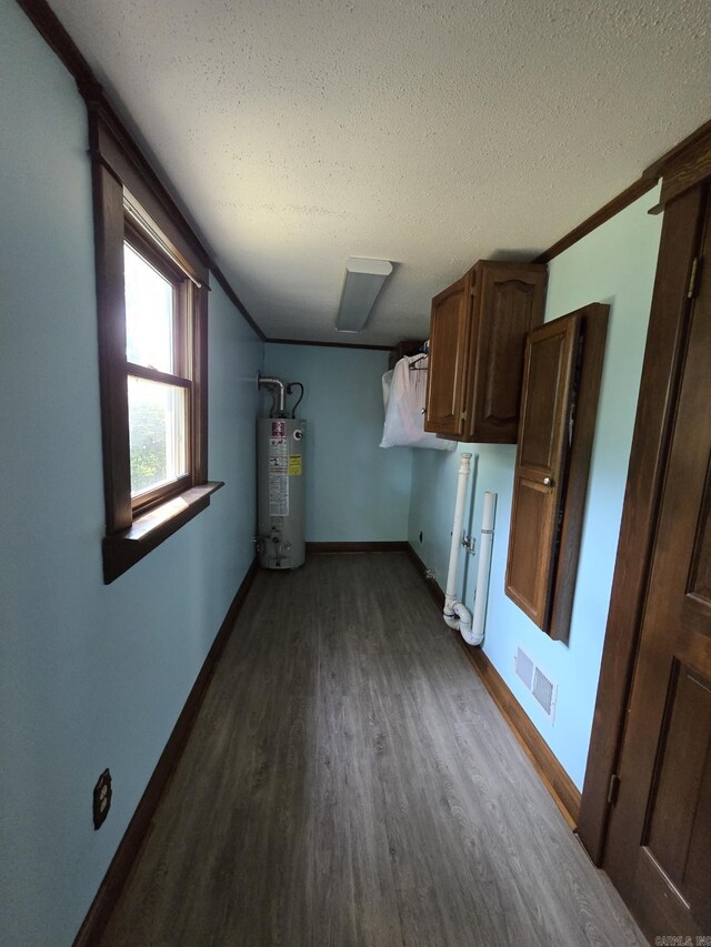 unfurnished living room featuring dark wood-type flooring, a textured ceiling, ceiling fan, and crown molding