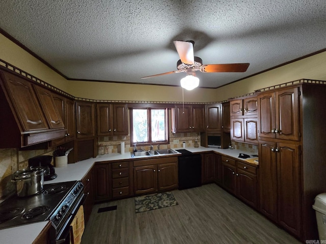 kitchen featuring black appliances, tasteful backsplash, a textured ceiling, dark brown cabinets, and dark hardwood / wood-style floors