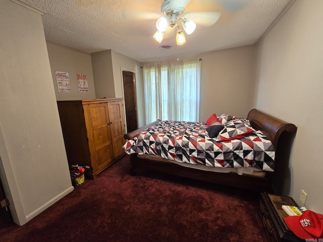 bedroom featuring a textured ceiling, dark colored carpet, and ceiling fan