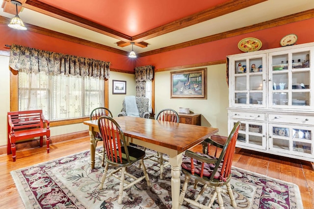 dining area featuring light wood-type flooring and ornamental molding