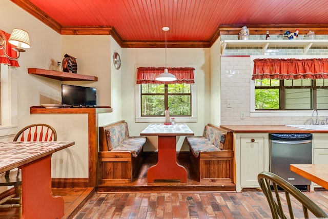 dining area featuring breakfast area, ornamental molding, and sink