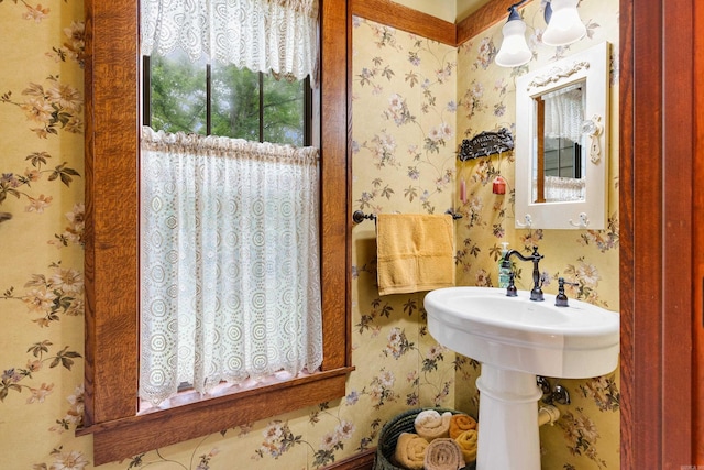 bathroom with a chandelier