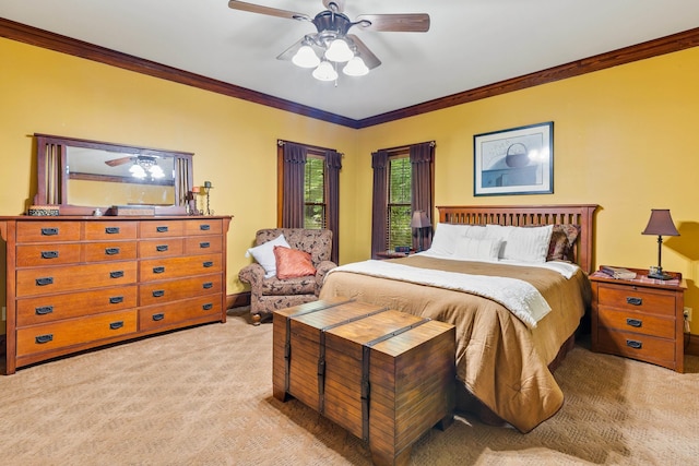 carpeted bedroom with ceiling fan and ornamental molding