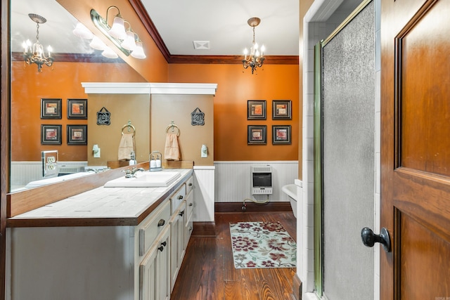 bathroom featuring heating unit, crown molding, wood-type flooring, and a notable chandelier