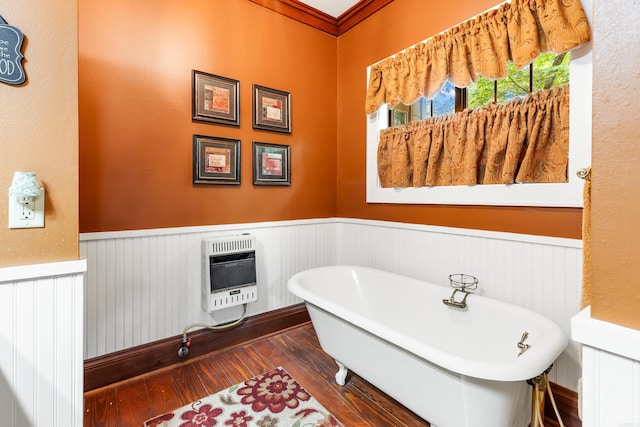 bathroom with heating unit, a washtub, and hardwood / wood-style flooring