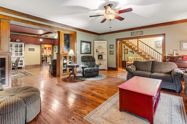 living room with ceiling fan, ornamental molding, and hardwood / wood-style flooring