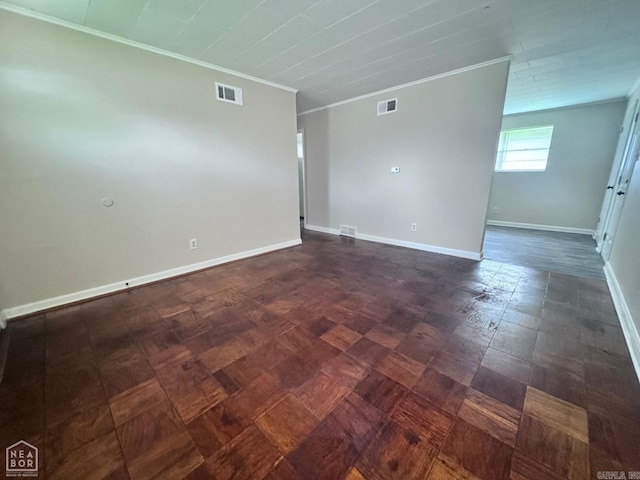 tiled spare room featuring ornamental molding