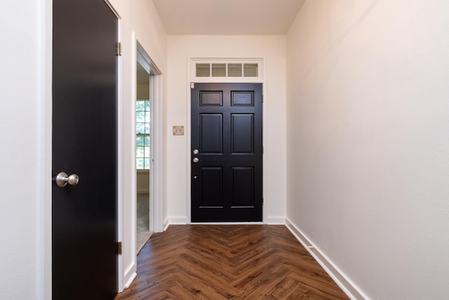 doorway to outside featuring dark parquet flooring