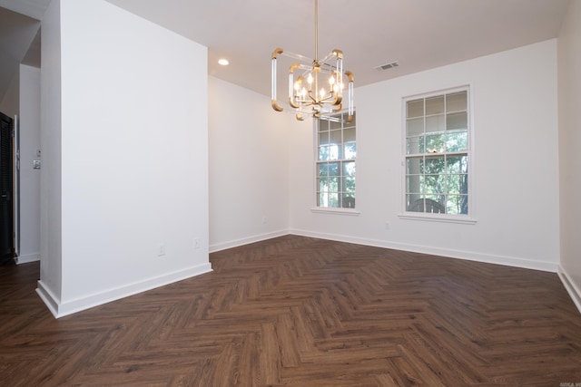 unfurnished room with dark parquet flooring and a chandelier