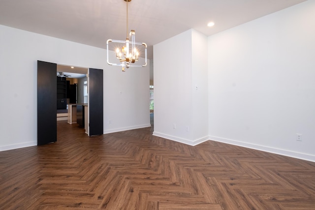 unfurnished room with a notable chandelier and dark parquet floors