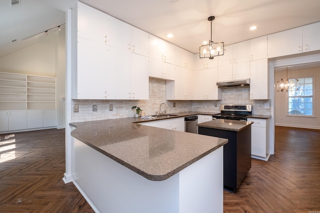 kitchen featuring stainless steel appliances, a center island, a notable chandelier, and dark parquet floors