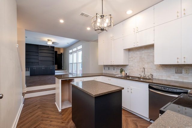 kitchen featuring pendant lighting, white cabinetry, a center island, and dark parquet floors