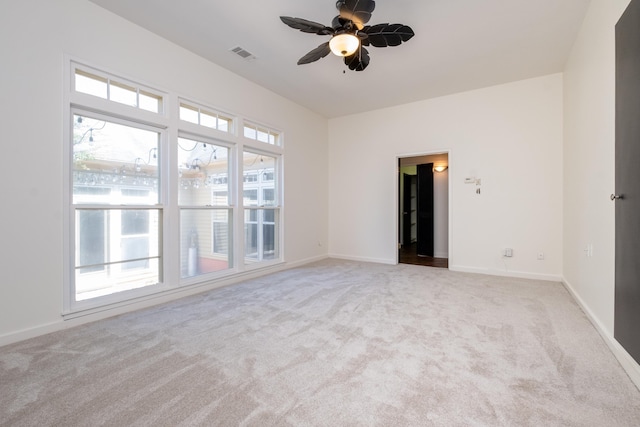 carpeted spare room featuring ceiling fan