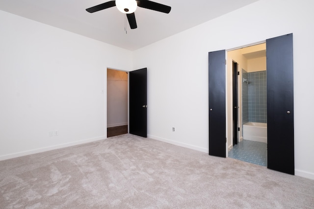 unfurnished bedroom featuring ceiling fan, connected bathroom, and light carpet