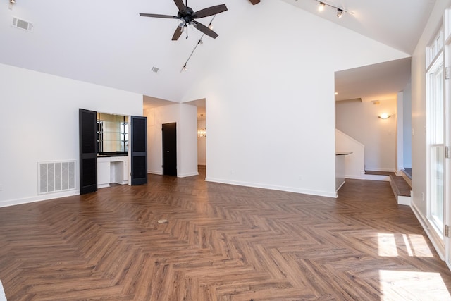 unfurnished living room featuring ceiling fan, high vaulted ceiling, and dark parquet floors