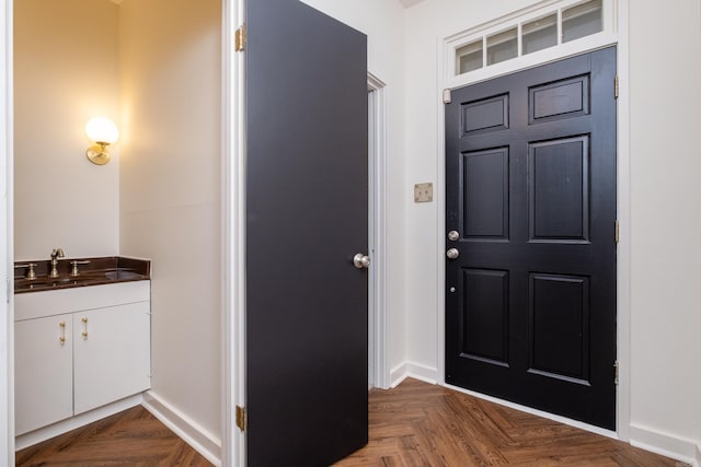 foyer with sink and dark parquet floors