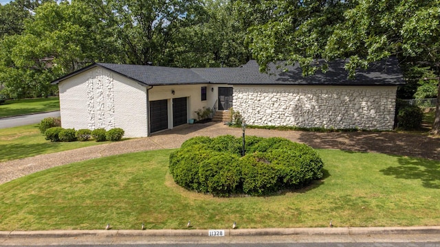 single story home featuring a garage and a front yard