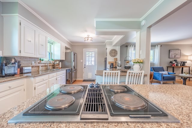 kitchen with light hardwood / wood-style floors, white cabinets, and backsplash