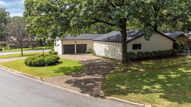 view of front of house with a garage and a front lawn