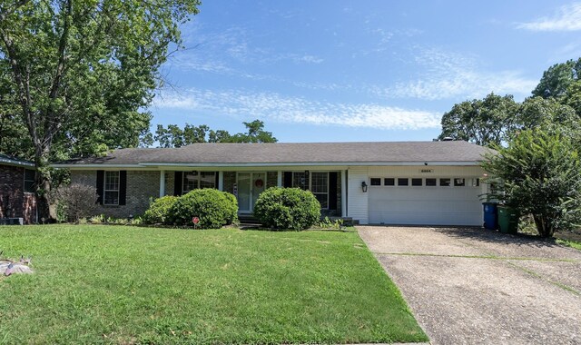 ranch-style house with a garage and a front lawn