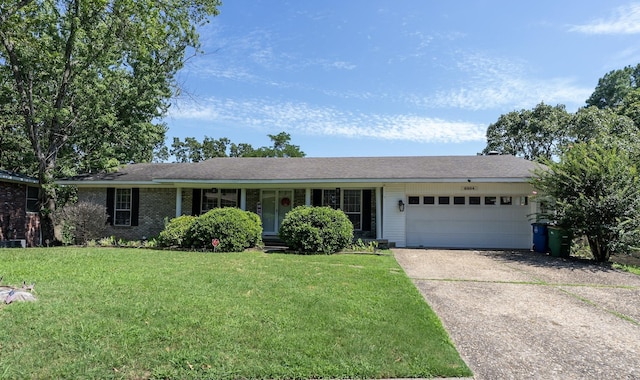 ranch-style home with a garage and a front lawn